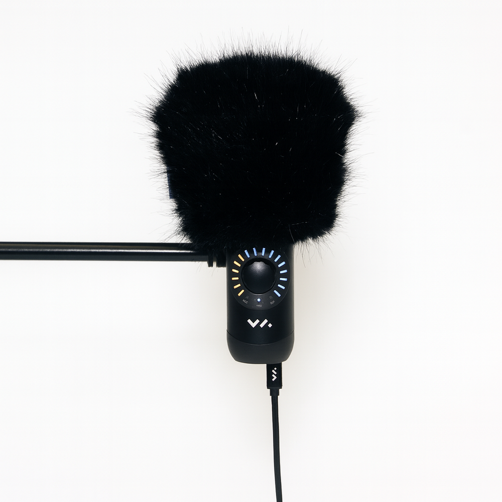 Black microphone with windscreen on a white background